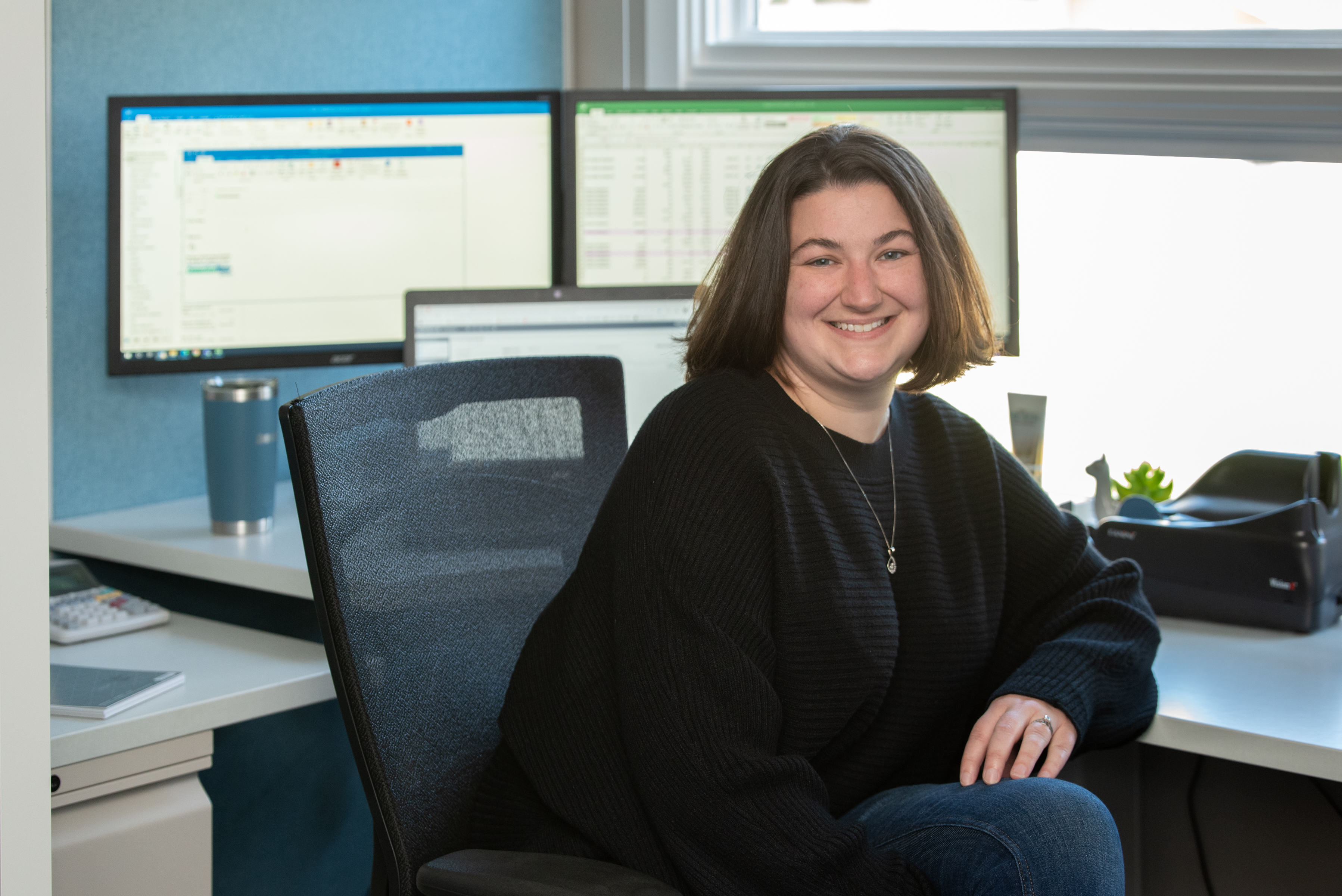 CT Water employee at their desk looking at the camera and smiling