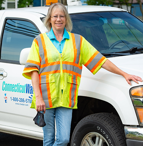 CT Water employee standing in front of a work truck
